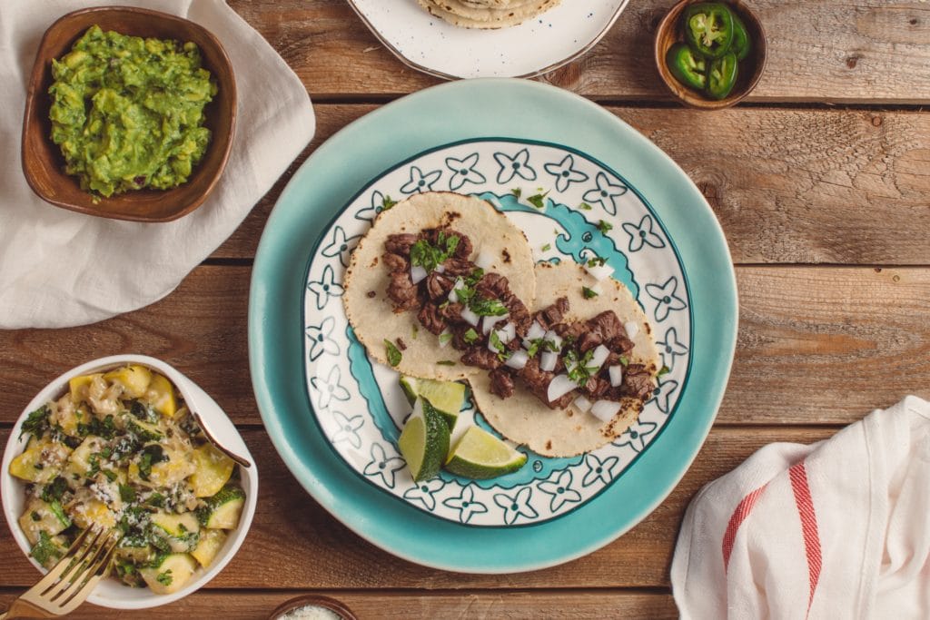 Photo of tacos on a plate with a side of guacamole San Diego San Diego