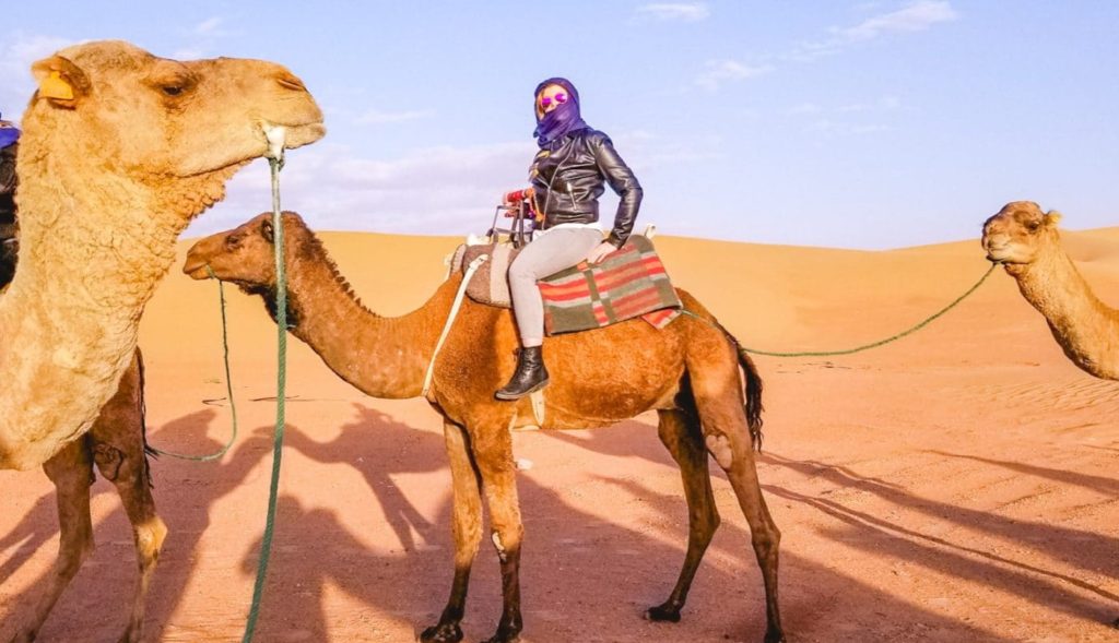 Eden Fite on a camel in the Sahara desert, Morocco