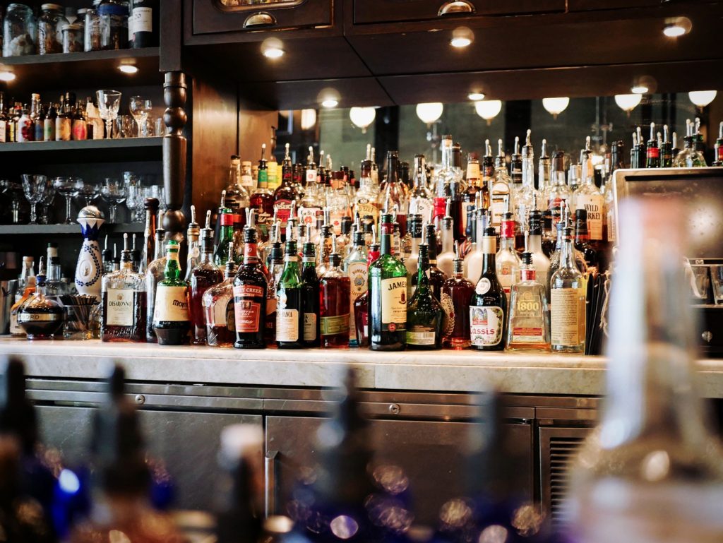 Bottles of alcohol sitting on a bar