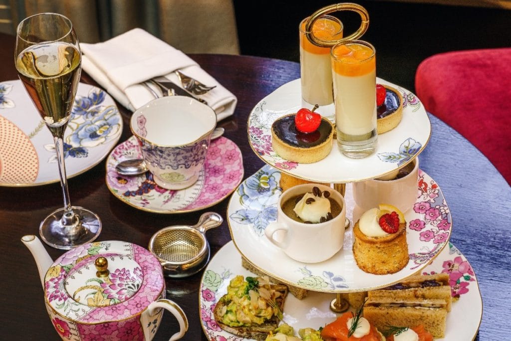 Fancy and colorful afternoon tea set up with tiered dessert tray