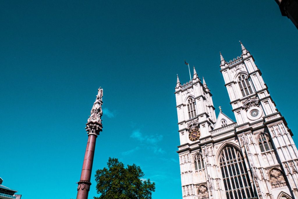 Looking up at Westminster Abbey in London with a deep blue sky in the background