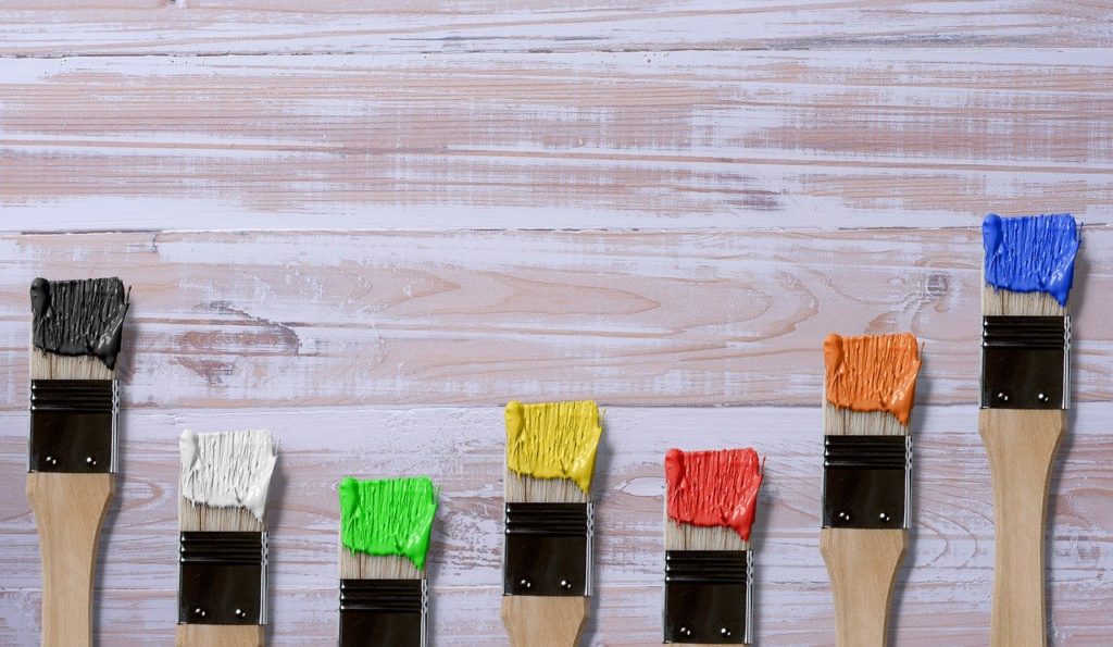 paint brushes on wooden table