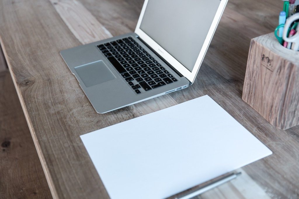 laptop on a desk for travel blogging