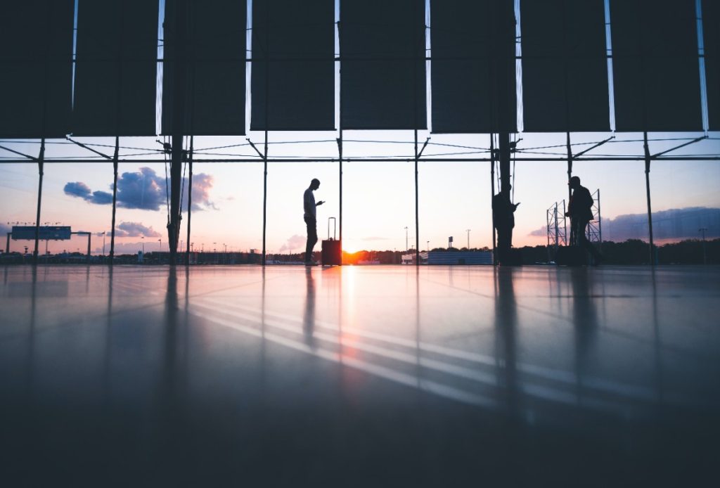 Person standing in front of a window at the airport